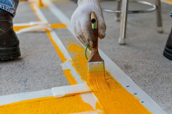 Line marking paint application with a brush